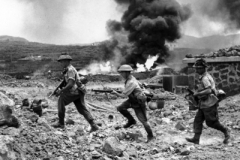 1942 Pantelleria Island 1DWR Soldiers running past a burning petrol dump